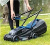 A person is using a cordless lawnmower on a grassy lawn. Náhled obrázku produktu