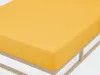 A close-up view of a yellow fitted sheet on a bed frame. Produktbild-Vorschau
