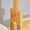 A close-up view of a wooden desk's height adjustment mechanism. Produktbild-Vorschau