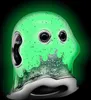 A close-up, studio shot of a green, ghost-shaped charm with black eyes and glittery details. Produktbild-Vorschau