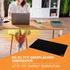 A person is working on a laptop at a desk, with a heating mat on the floor. Produktbild-Vorschau