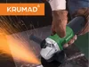 A person wearing gloves is using a green and black angle grinder, creating sparks. Produktbild-Vorschau
