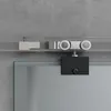 A close-up view of a sliding glass door mechanism against a concrete wall. Produktbild-Vorschau