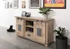 A wooden sideboard with sliding doors in a room setting, decorated with plants and framed pictures on the wall. Voir les images du produit