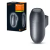 A dark gray outdoor wall light and its packaging are shown against a white background. Produktbild-Vorschau
