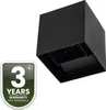 A black cube-shaped outdoor wall light is shown against a white background, with a warranty badge in the lower left corner. Voir les images du produit