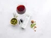 A wine vacuum sealer set is displayed with a glass of red wine, olives, and walnuts on a textured light gray background. Produktbild-Vorschau