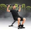 A man is performing an exercise with dumbbells on an adjustable weight bench. Podgląd zdjęcia produktu