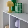 A close-up view of a white bookshelf with decorative items on top and inside. Anteprima dell’immagine prodotto