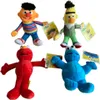 Four Sesame Street plush toys are arranged in a playful pose against a white background. Produktbild-Vorschau