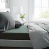 A close-up view of a bed with bedding. Produktbild-Vorschau