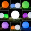 A collage of different colored solar LED garden lights on grass at night. Produktbild-Vorschau