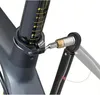 A close-up view of a torque wrench being used to tighten a bolt on a bicycle seat post clamp. Voir les images du produit