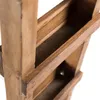 A close-up view of a wooden ladder shelf, showing the texture and construction of the shelves. Náhled obrázku produktu