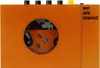 An orange portable cassette player with a circular window showing the cassette mechanism. Náhled obrázku produktu