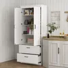 A white kitchen pantry cabinet with its doors open, revealing shelves stocked with various items. The cabinet is placed in a kitchen setting with a wooden countertop and a decorative sign on the wall. Anteprima dell’immagine prodotto