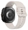 The back view of a smartwatch with a beige silicone strap.