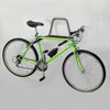 A green bicycle is mounted on a wall rack against a white background. Produktbild-Vorschau