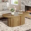A living room scene with a coffee table, sofa, and fireplace. Voir les images du produit