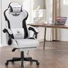 A gaming chair is shown in a room with a desk and laptop. Náhled obrázku produktu