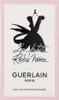 The image shows the front of a perfume box with a stylized illustration of a black dress on a mannequin. Voir les images du produit