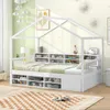 A white house-shaped bed with integrated shelving and drawers, set in a child's bedroom with decorative clouds and wall art. Produktbild-Vorschau