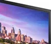 A close-up view of a monitor displaying a cityscape at sunset. Produktbild-Vorschau