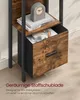 A close-up view of a shelf unit with a fabric drawer, showing books, headphones, and a clock. Produktbild-Vorschau