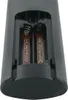 Close-up view of the battery compartment of a remote control, showing two AAA batteries inserted. Podgląd zdjęcia produktu