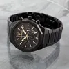 A black Maserati chronograph watch with gold accents is displayed on a reflective gray surface. Náhľad obrázku produktu