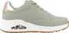 A side view of a green Skechers Uno sneaker with a white sole and a rose gold heel accent. Voir les images du produit