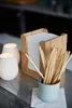 A close-up shot of candle holders and breadsticks on a counter. Produktbild-Vorschau