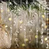 Christmas ornaments hanging from a tree branch. Náhľad obrázku produktu
