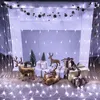 Christmas decorations with lights and reindeer figurines in front of a fireplace. Produktbild-Vorschau
