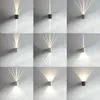 A grid of nine images showing different wall lights mounted on a textured wall, each emitting light in various patterns. Anteprima dell’immagine prodotto