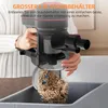 A person is emptying the dustbin of a vacuum cleaner into a trash can. Voir les images du produit