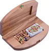 A wooden box containing a deck of cards and small wooden pegs, likely for a board game. Náhled obrázku produktu