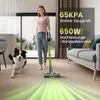 A woman is vacuuming a floor with a cordless vacuum cleaner while a dog runs nearby. Green light trails emanate from the vacuum cleaner. Produktbild-Vorschau
