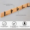 A wall-mounted coat rack made of bamboo with black metal hooks, shown with informational text and icons. Produktbild-Vorschau