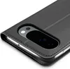 A close-up view of a black flip-style phone case, showing the camera cutout with lenses and flash. Produktbild-Vorschau