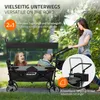 A woman pushing a wagon with two children in it, outdoors. Náhled obrázku produktu