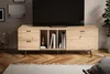 A modern TV stand with a TV on top, placed in a living room setting with a rug and a plant. Produktbild-Vorschau
