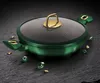 A green pot with a glass lid and gold accents, surrounded by decorative green gems and gold nuggets on a dark, textured surface. Anteprima dell’immagine prodotto