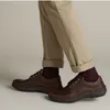 A person wearing brown leather shoes and khaki pants. Anteprima dell’immagine prodotto