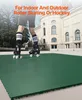 A person wearing roller skates stands on a green interlocking floor in front of a building. Podgląd zdjęcia produktu