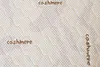 A close-up view of a quilted mattress cover with the word 'cashmere' printed on it. Náhľad obrázku produktu