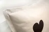 A close-up view of a pillowcase with a black heart design. Produktbild-Vorschau