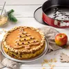 A Christmas-themed cake and baking accessories are arranged on a white wooden surface. Produktbild-Vorschau