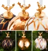 A collage of Christmas ornaments with deer heads, some on a white background and others on a Christmas tree. Podgląd zdjęcia produktu