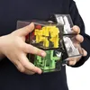 A child's hands are holding a clear cube-shaped puzzle with colorful internal maze-like structures. Podgląd zdjęcia produktu